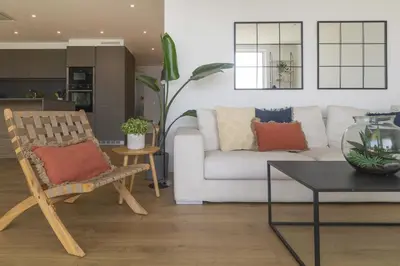 a living room with a couch and a chair at Vivalidays Apartour - Calella in Calella