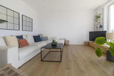 a living room with a white couch and a table at Vivalidays Apartour - Calella in Calella