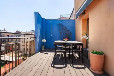 a patio with two chairs and a table on a balcony at The Collection Barcelona - 3-bedroom penthouse with terrace in Eixample in Barcelona