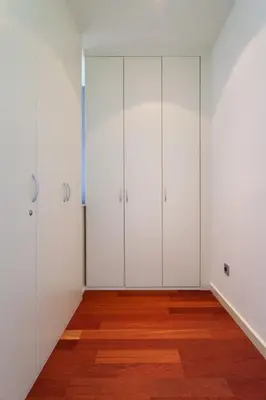 a bedroom with white cabinets and a bed and a window at The Collection Barcelona - Wonderful 2-bd apart with balcony Plaza Cataluña in Barcelona