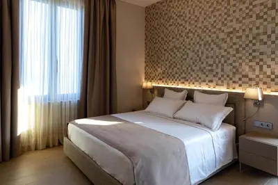 a bedroom with a large bed and a large window at AB BOUTIQUE HOTEL - Adults only in Sant Vicenç de Montalt