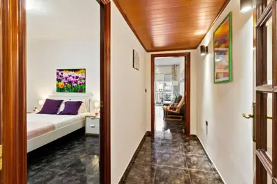 a bedroom with a bed with a painting on the wall at Stay U-nique Apartments La Bordeta in Barcelona