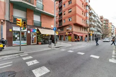 an empty city street with a traffic light and buildings at Stay U-nique Apartments La Bordeta in Barcelona