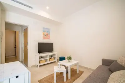 a living room with a couch and a tv at NICE CENTRIC APARTMENT in Vilanova i la Geltrú