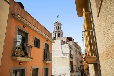 a view of a building with a clock tower in the background at NICE CENTRIC APARTMENT in Vilanova i la Geltrú