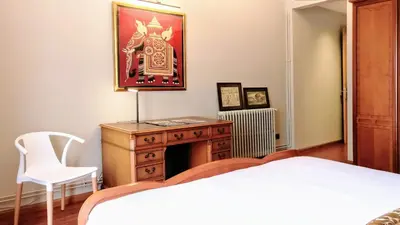 a bedroom with a bed and a dresser with a fireplace at BizFlats Eixample Apartments in Barcelona