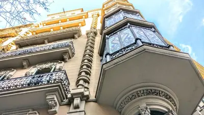 a tall building with a clock on top of it at BizFlats Eixample Apartments in Barcelona