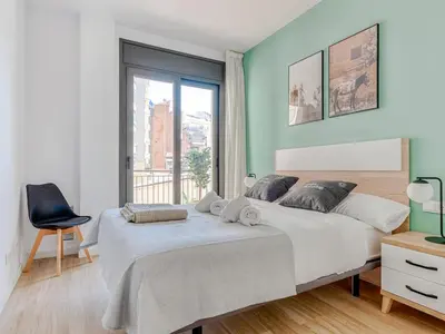 a bedroom with a large bed and a window at Limehome Barcelona Carrer de Besalú 90 - estancia temporal in Barcelona