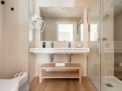 a bathroom with a sink and a shower at Limehome Barcelona Carrer de Besalú 82 in Barcelona