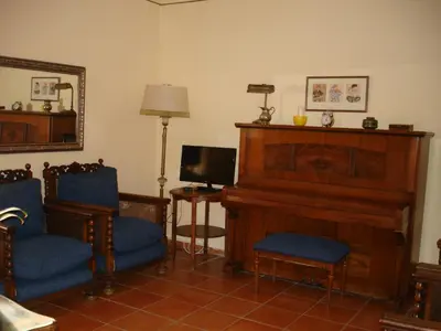 a living room with a table and chairs and a door at MAS GUILLO in San Quintín de Mediona