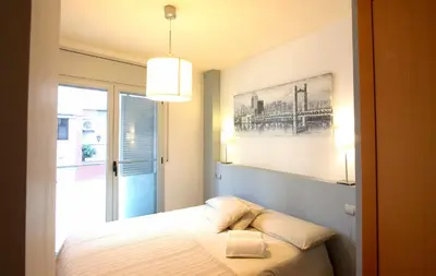 a bedroom with a bed with a picture on the wall at Mazi Apartments Downtown in Mataró