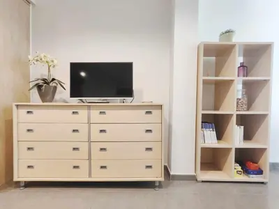 a dresser with a tv on top of it at Mazi Apartments Nest in Mataró