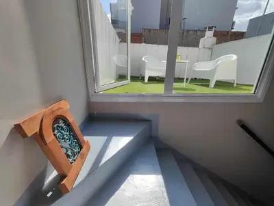 a room with a window and a table and chairs at Mazi Apartments Penthouse in Badalona
