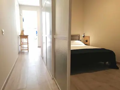 a bedroom with a bed and a large mirror at Mazi Apartments Chic in Badalona