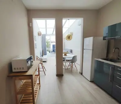 a kitchen with a counter and a table with a microwave at Mazi Apartments Chic in Badalona