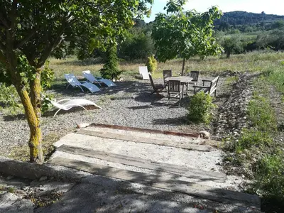 a group of chairs and a table in a field at LA NURSERY DE MAS GUILLO in San Quintín de Mediona