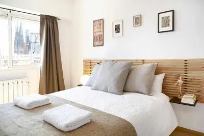 a bedroom with a large bed with two pillows on it at SAGRADA FAMILIA VIEWS Nos preocupa su seguridad. in Barcelona