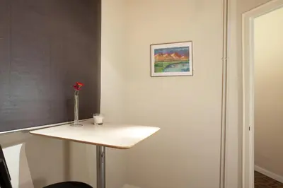 a table with a vase with a flower on it at Modernist Apartment Barcelona in Barcelona