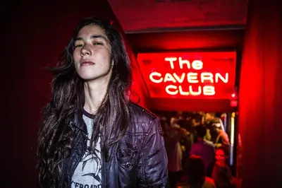 a woman standing in front of a neon sign at Sant Jordi Hostels Rock Palace in Barcelona