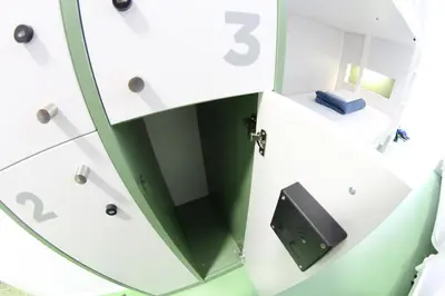 a bathroom with a mirror in a white cabinet at Sant Jordi Hostels Rock Palace in Barcelona