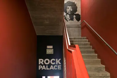 an orange staircase with a rock palace sign on the wall at Sant Jordi Hostels Rock Palace in Barcelona