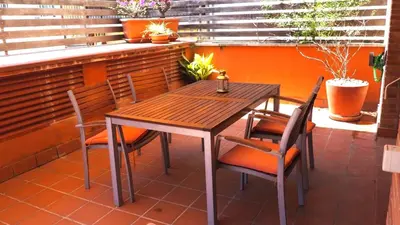 a wooden table and chairs on a patio at BRAVAHOLIDAYS-201-Pineda in Pineda de Mar