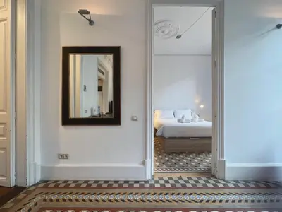 a bedroom with a bed and a mirror at Stay Unique Apartments Bruc in Barcelona