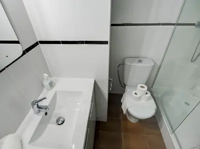 a white bathroom with a toilet and a shower at Clarimar Sky Blue by Hello Homes Sitges in Sitges