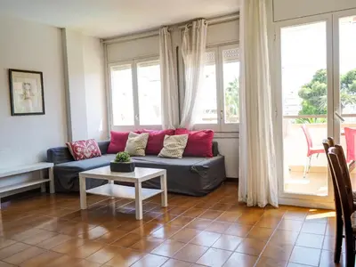 a living room with a couch and a table at Clarimar Sky Blue by Hello Homes Sitges in Sitges
