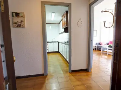 a room with a hallway with a kitchen and a floor at Clarimar Sky Blue by Hello Homes Sitges in Sitges