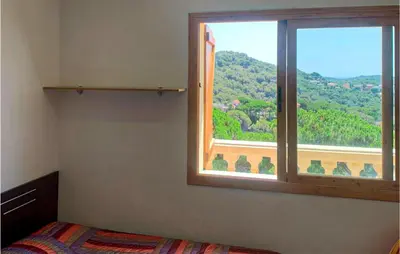 a bedroom with a window with a view of a mountain at Nice Home In Sant Cebria De Vallalt in Sant Cebrià de Vallalta