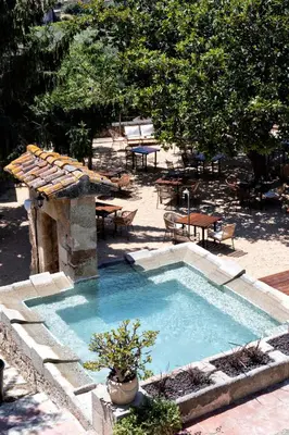 a small swimming pool with a table and chairs at La Mer Hotel in Cabrera de Mar