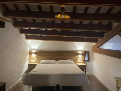 a bedroom with a large bed in a attic at La Mer Hotel in Cabrera de Mar