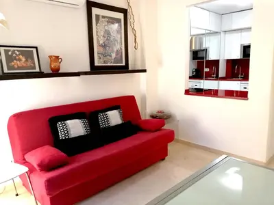 a red couch in a living room with a glass table at Enric Granados 15 in Barcelona