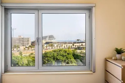 a window with a view of a city at Lodging Apartments Forum Llull in Sant Adria de Besos