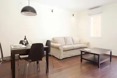 a living room with a table and a couch at Apart céntrico con terraza en Gracia in Barcelona