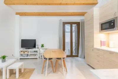 a living room with a table and a tv at NICE CITY CENTER APARTMENT in Vilanova i la Geltrú