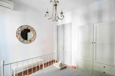 a bedroom with a bed and a mirror and a chandelier at Port VIII Apart céntrico en Paralelo cerca Rambla in Barcelona