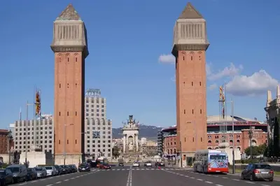 two tall towers in a city with a street at Port VIII Apart céntrico en Paralelo cerca Rambla in Barcelona