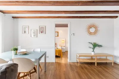 a living room with a blue table and chairs at Lodging Apartments Liceu G1 in Barcelona