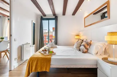a large white bedroom with a large bed in a room at Lodging Apartments Liceu G1 in Barcelona
