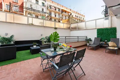 an apartment patio with a table and chairs at Lodging Apartments Liceu 11 in Barcelona