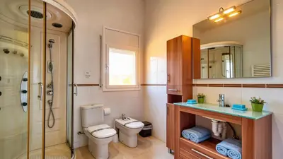 a kitchen with a counter and some chairs in it at Villa Sitges Ilusión 15 minutes by car from Sitges Sleeps 16 people XXL swimming pool in Olivella