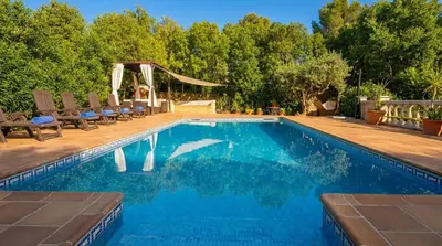 a hot tub in the middle of a patio at Villa Sitges Ilusión 15 minutes by car from Sitges Sleeps 16 people XXL swimming pool in Olivella