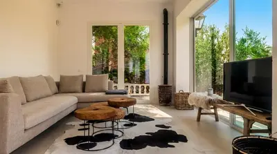 a dining room with a table and a bench at Villa Sitges Colonial. Impressive views of the sea. High design. Renovated. in Sitges