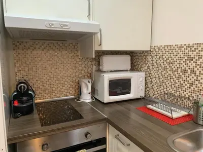 a kitchen counter with a microwave and a sink at Nice apartment close to park Guell1 in Barcelona