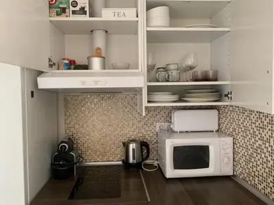 a kitchen with a microwave and a counter top at Nice apartment close to park Guell1 in Barcelona