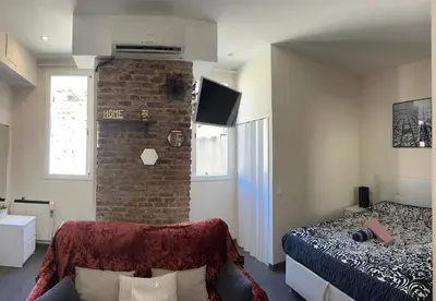 a bedroom with a bed and a brick wall at Nice apartment close to park Guell1 in Barcelona
