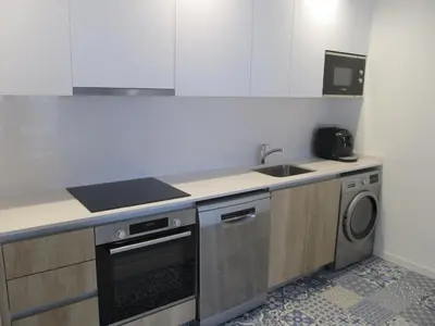 a kitchen with a sink and a dishwasher at Family Apartment in Vilanova i la Geltrú