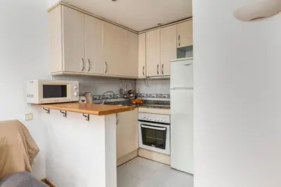 a kitchen with white appliances and a white refrigerator at Estudio Bogatell Beach Se admiten mascotas AC in Barcelona